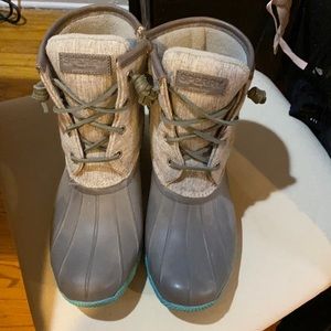 Gray duck boots with turquoise soles.